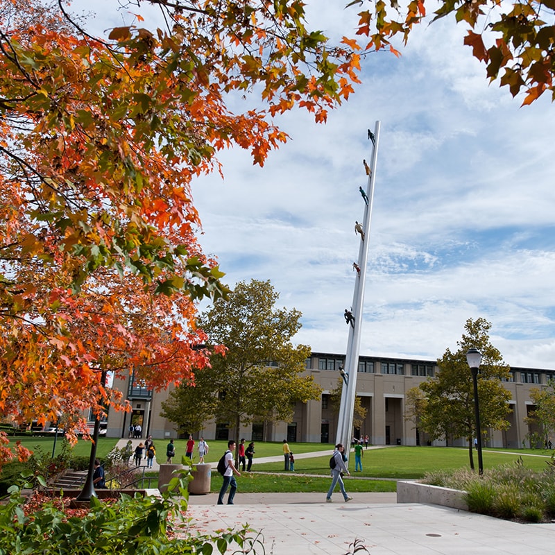 Photo of campus and students walking on a fall day